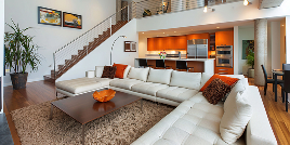 Living room with a staircase and kitchen